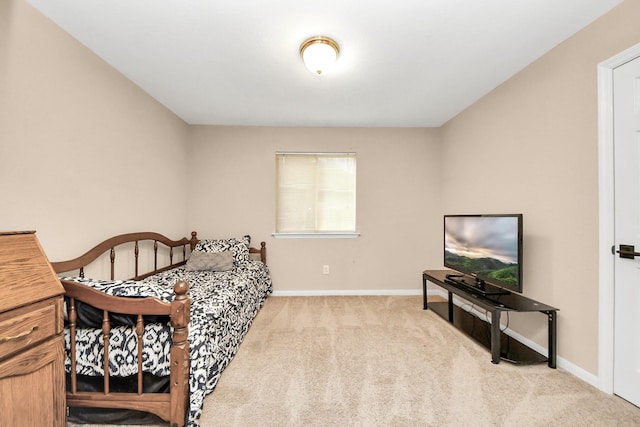 bedroom with baseboards and carpet