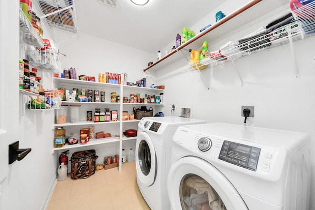 laundry room with laundry area, separate washer and dryer, and tile patterned floors