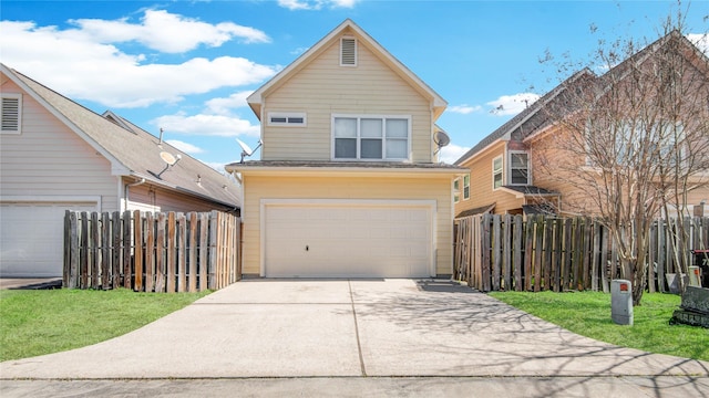 traditional home featuring concrete driveway, an attached garage, fence, and a front lawn