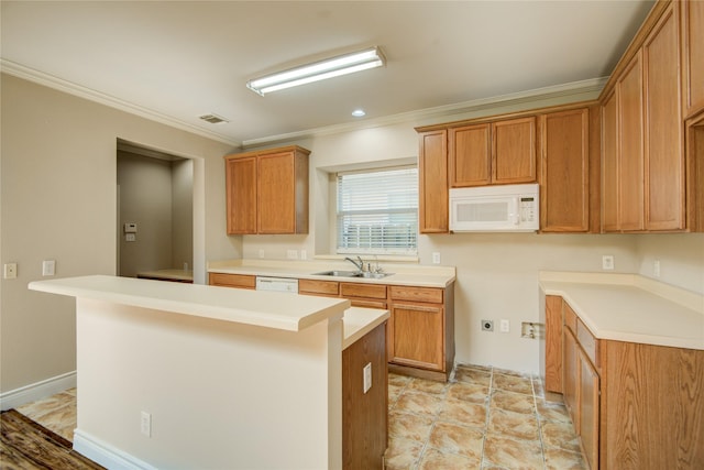 kitchen featuring a sink, visible vents, white microwave, and ornamental molding