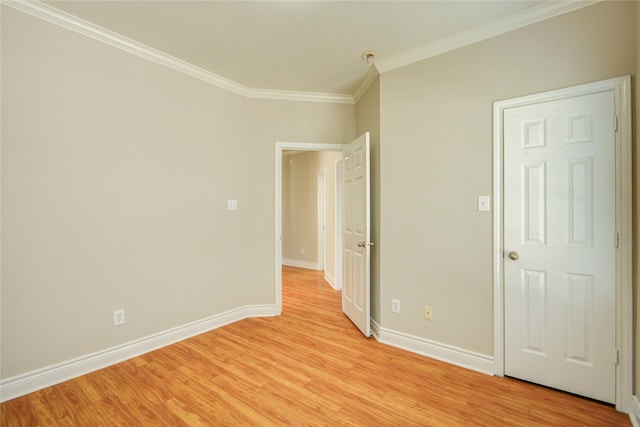 unfurnished bedroom featuring light wood-style floors, baseboards, and ornamental molding