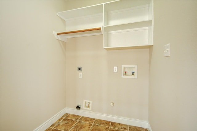 clothes washing area featuring electric dryer hookup, baseboards, gas dryer hookup, hookup for a washing machine, and laundry area