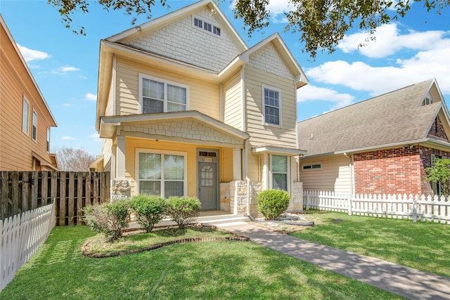 view of front of home with a front yard and fence