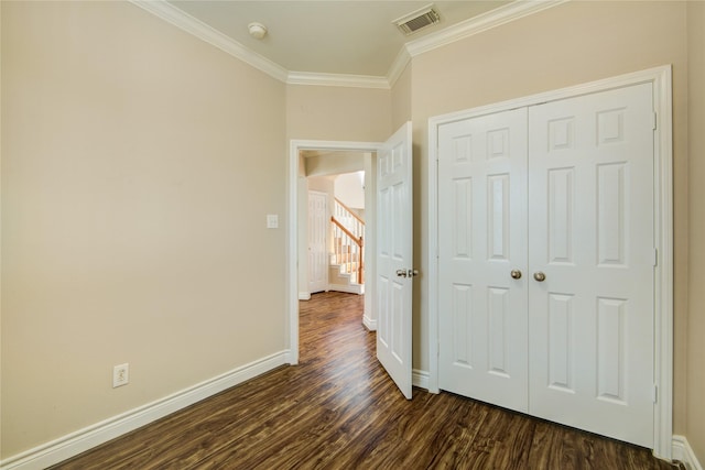 interior space with visible vents, baseboards, dark wood-type flooring, and crown molding