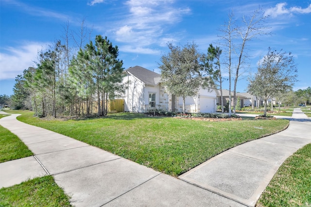 view of front of property with a garage and a front yard