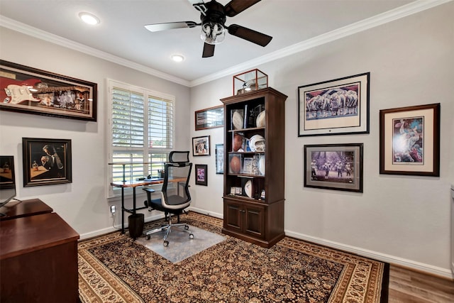 office space with baseboards, wood finished floors, ornamental molding, and a ceiling fan