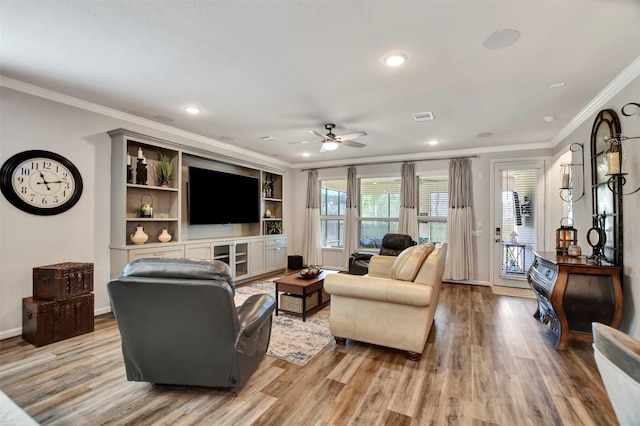 living room with visible vents, baseboards, ornamental molding, recessed lighting, and light wood-style flooring