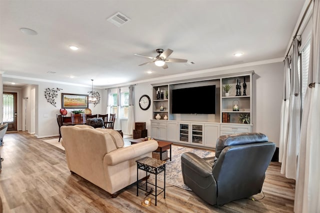 living area featuring visible vents, recessed lighting, crown molding, and light wood-type flooring