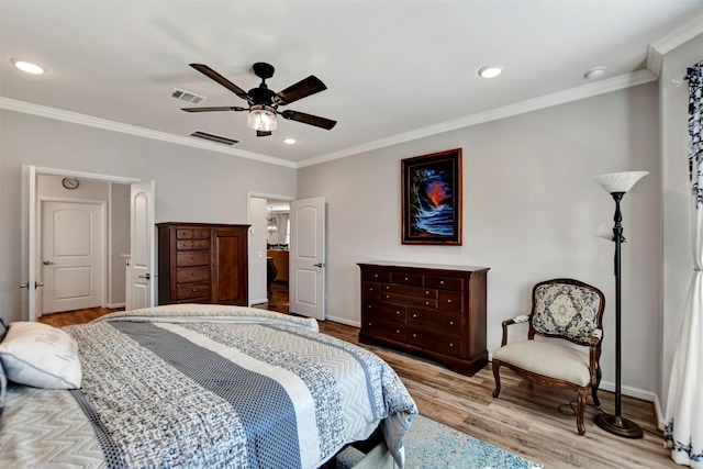 bedroom featuring visible vents, recessed lighting, crown molding, and wood finished floors