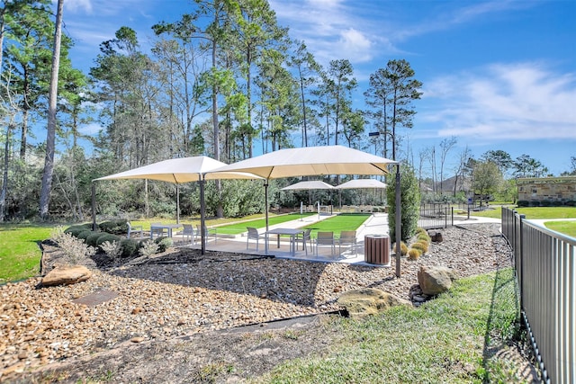 exterior space with fence and a lawn