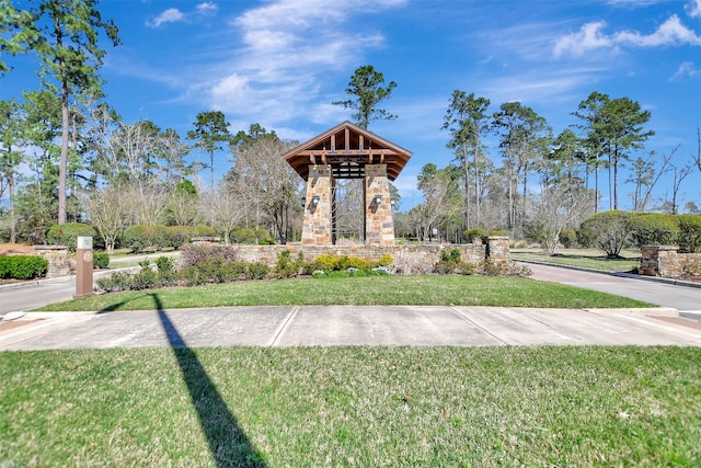 view of home's community with a lawn