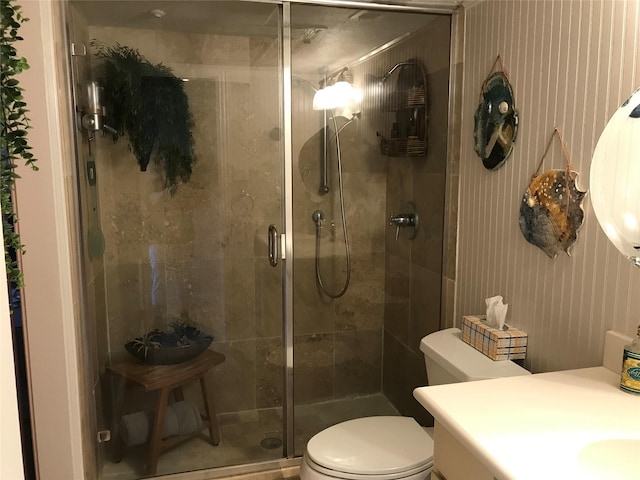 full bathroom with a stall shower, toilet, and vanity