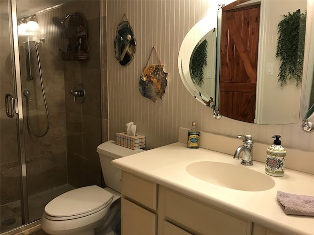 full bath featuring vanity, toilet, and a stall shower