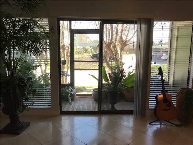 doorway to outside featuring tile patterned floors