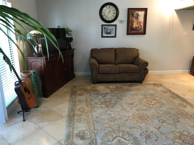 sitting room featuring light tile patterned floors and baseboards