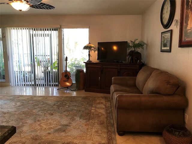 living room with light tile patterned flooring and ceiling fan