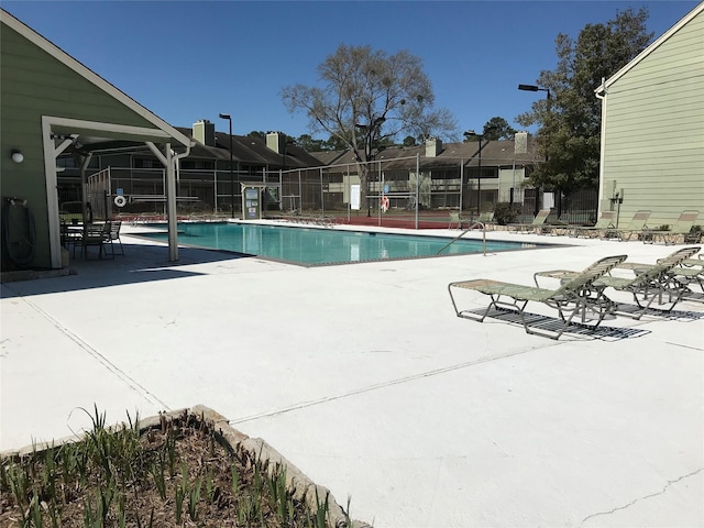 pool featuring a patio and fence