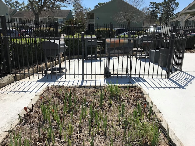 view of gate featuring fence and a residential view