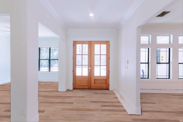 entrance foyer with french doors, baseboards, light wood finished floors, and ornamental molding