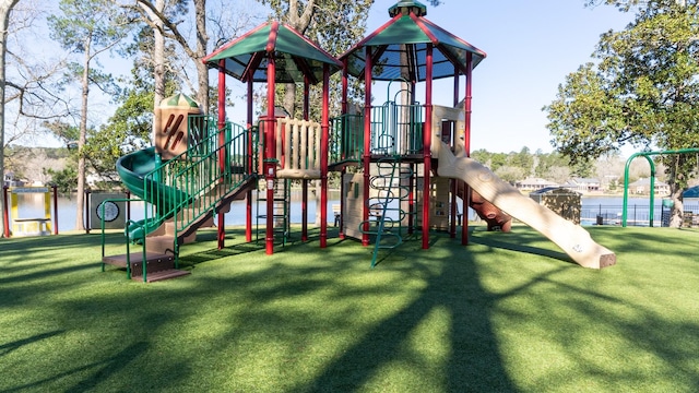 community playground featuring a yard and fence