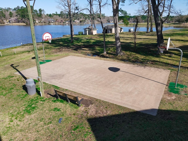 exterior space with community basketball court and a lawn