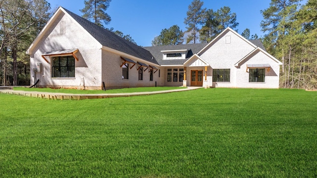 view of front of property featuring a front lawn and brick siding