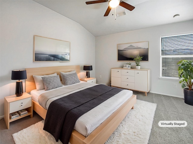 carpeted bedroom featuring visible vents, baseboards, a ceiling fan, and vaulted ceiling