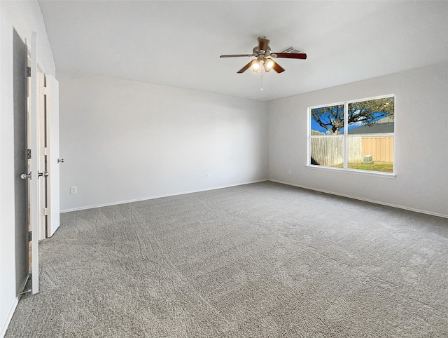 unfurnished room featuring carpet, baseboards, and ceiling fan