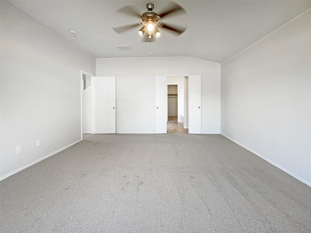 unfurnished bedroom featuring visible vents, a ceiling fan, carpet flooring, baseboards, and a spacious closet