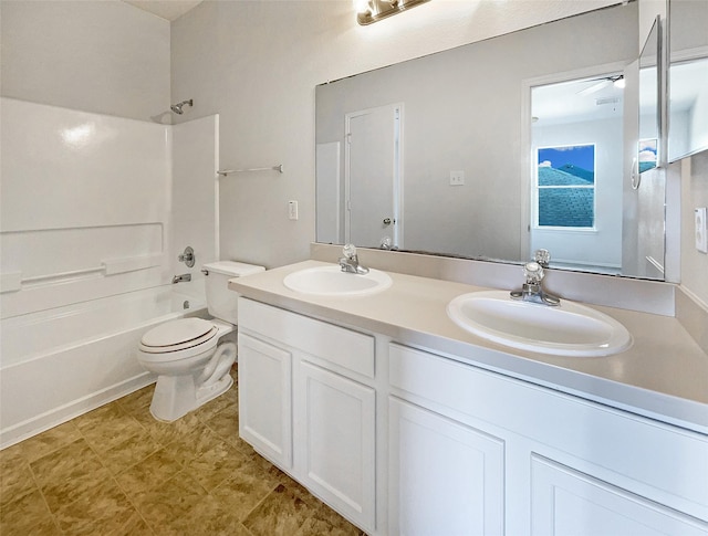 full bathroom featuring a sink, toilet, shower / washtub combination, and double vanity