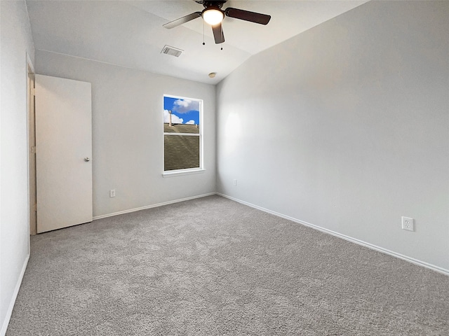 spare room with carpet, visible vents, baseboards, ceiling fan, and vaulted ceiling