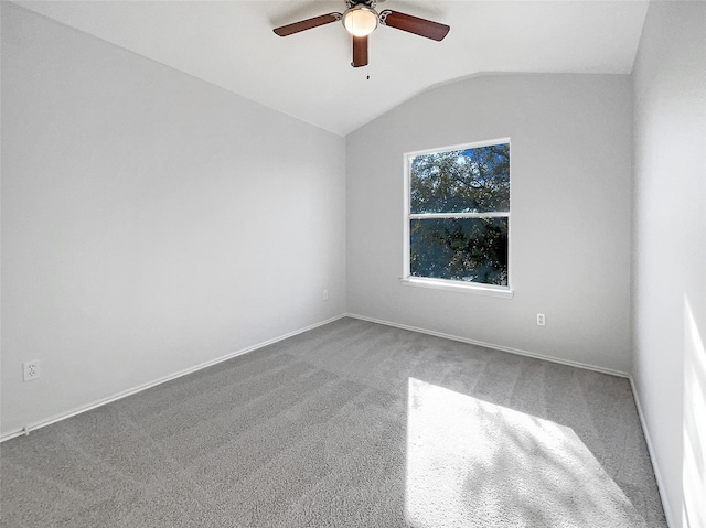 unfurnished room featuring vaulted ceiling, a ceiling fan, baseboards, and carpet floors