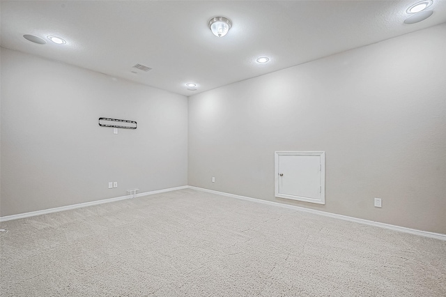 unfurnished room with light colored carpet, recessed lighting, baseboards, and visible vents