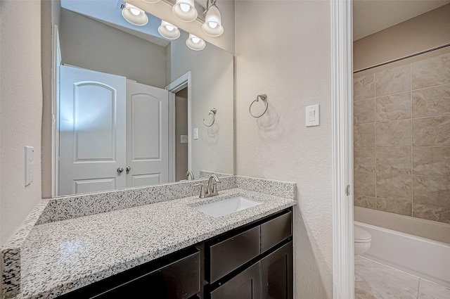 bathroom featuring toilet, vanity, and shower / tub combination