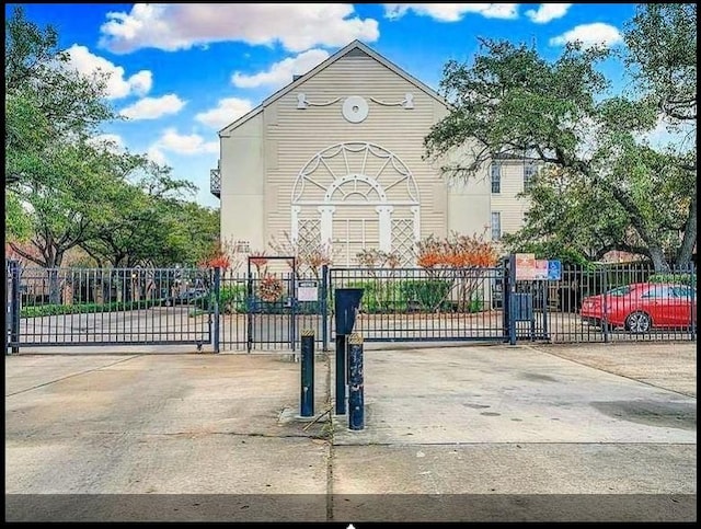 view of gate with fence