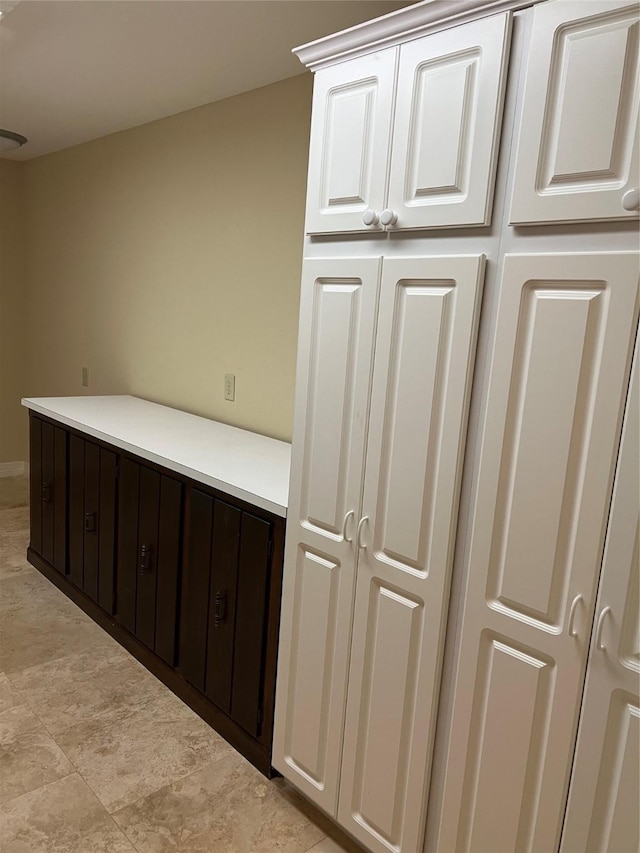 interior space featuring light countertops and white cabinetry