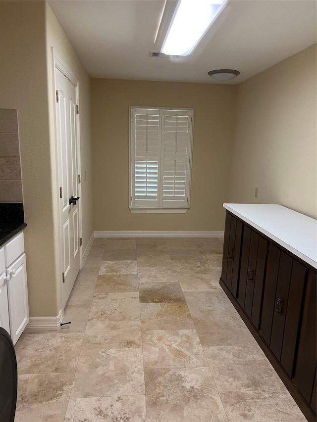 interior space featuring baseboards