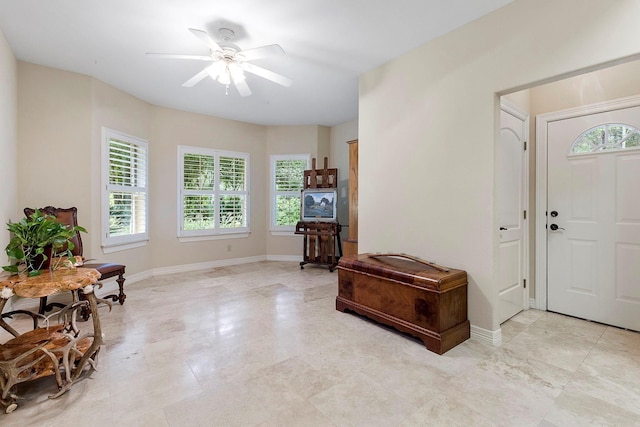 entrance foyer featuring baseboards and ceiling fan