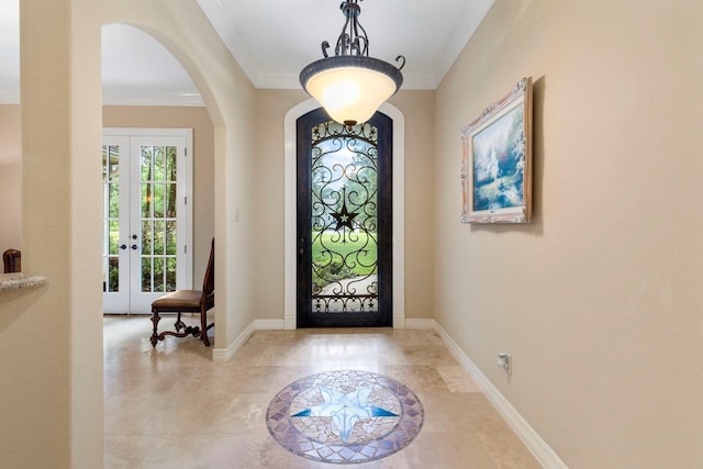 entrance foyer featuring french doors, baseboards, and ornamental molding