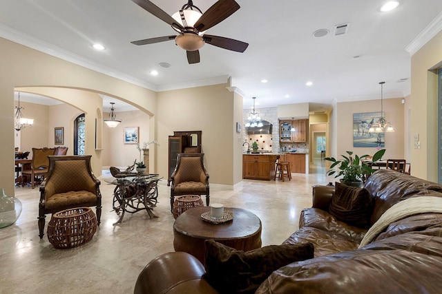 living room featuring arched walkways, visible vents, recessed lighting, and crown molding