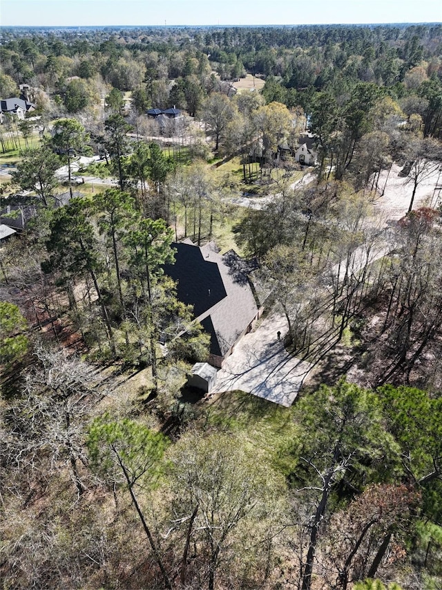 birds eye view of property featuring a view of trees