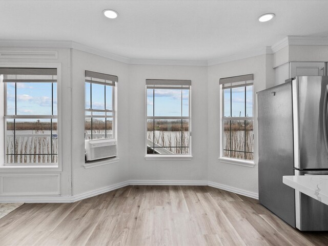 unfurnished dining area with cooling unit, crown molding, light wood-type flooring, baseboards, and recessed lighting