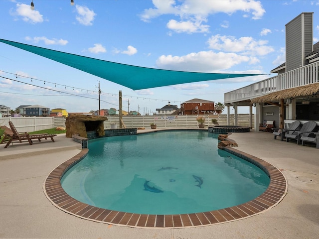 view of pool with a patio, a pool with connected hot tub, and a fenced backyard
