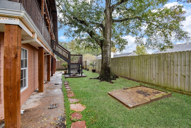 view of yard with stairway and a fenced backyard