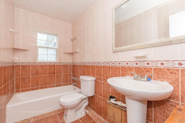 full bath with tile patterned flooring, tile walls, toilet, and shower / bathing tub combination