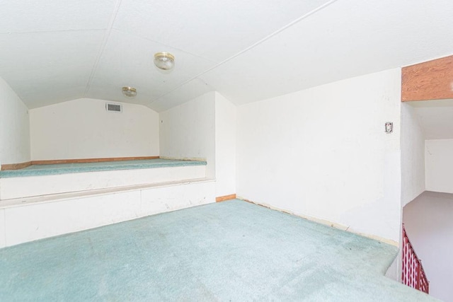 bonus room featuring visible vents, carpet floors, and vaulted ceiling