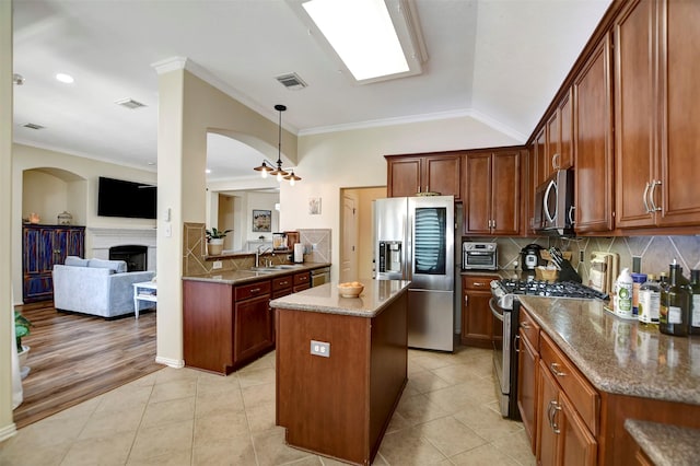 kitchen featuring light tile patterned floors, visible vents, appliances with stainless steel finishes, and a fireplace