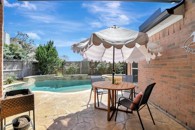 view of pool with outdoor dining space, a fenced in pool, a patio, and a fenced backyard