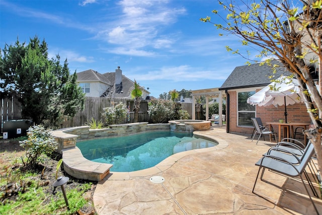 view of swimming pool featuring a patio, a fenced backyard, and a pool with connected hot tub