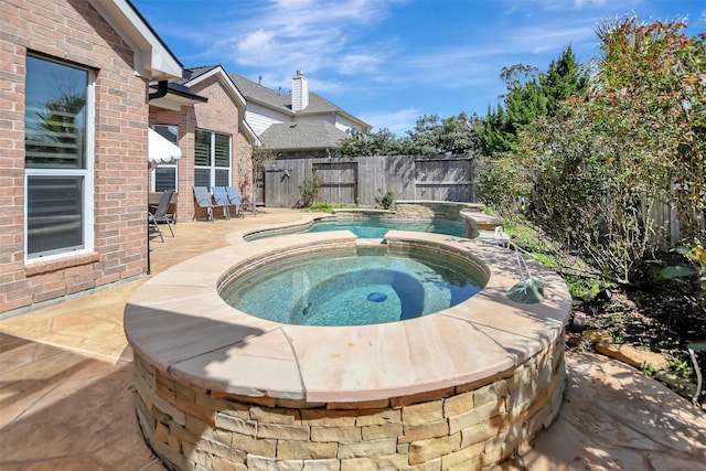 view of swimming pool featuring a patio area, a fenced in pool, an in ground hot tub, and a fenced backyard